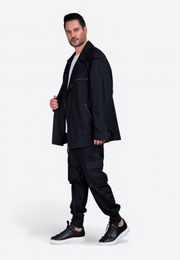 Model wearing black cotton trousers with tailored fit and cargo pockets East Vibe